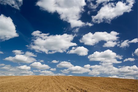 Blue sky with clouds over ploughed field. Stock Photo - Budget Royalty-Free & Subscription, Code: 400-04062445