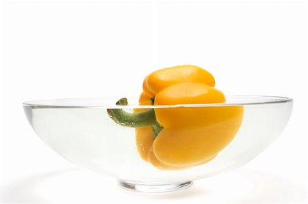 simsearch:400-07899696,k - Yellow paprika floating in vase with water over white background Photographie de stock - Aubaine LD & Abonnement, Code: 400-04062611