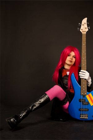Rock girl in crazy outfit sitting with bass guitar Stock Photo - Budget Royalty-Free & Subscription, Code: 400-04062856