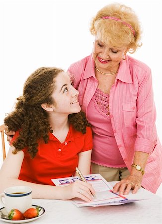 Grandmother helping her granddaughter fill out a mail-in voter registration form.  Isolated on white. Stock Photo - Budget Royalty-Free & Subscription, Code: 400-04062874