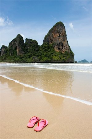 pink flip flops beach - Colorful pink flip flops on beach in Thailand, limestone rock in background Stock Photo - Budget Royalty-Free & Subscription, Code: 400-04062948