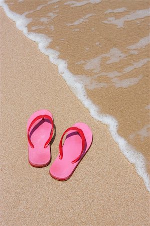 pink flip flops beach - Colorful pink flip flops on beach next to the water Stock Photo - Budget Royalty-Free & Subscription, Code: 400-04062949