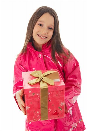 Young girl in a pink raincoat giving a present to the camera Stock Photo - Budget Royalty-Free & Subscription, Code: 400-04063176