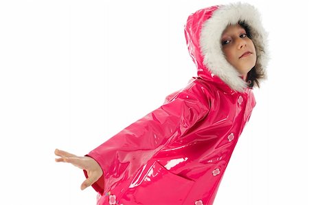 Young girl in a pink raincoat and woolly hood, making a dance pose Stock Photo - Budget Royalty-Free & Subscription, Code: 400-04063173