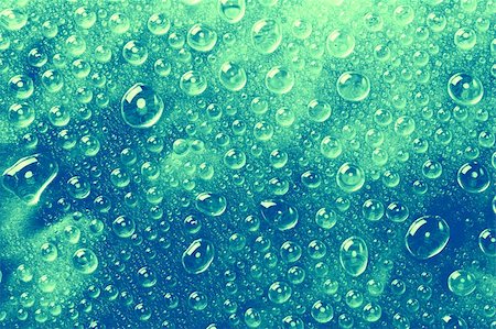 simsearch:400-04370982,k - Blue-green water drops on a glass surface. Photographie de stock - Aubaine LD & Abonnement, Code: 400-04074031