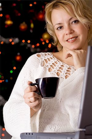 Woman at home with a laptop and a beverage in christmas time Stock Photo - Budget Royalty-Free & Subscription, Code: 400-04074895