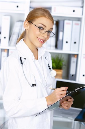 simsearch:400-04178933,k - Portrait of smiling female doctor in surgery with clipboard Stock Photo - Budget Royalty-Free & Subscription, Code: 400-04075506