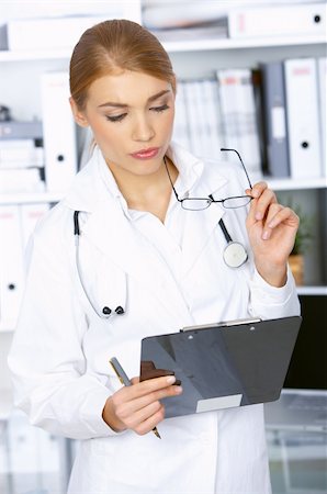 simsearch:400-04178933,k - Female doctor reading her notes in clipboard, in surgery Stock Photo - Budget Royalty-Free & Subscription, Code: 400-04075508