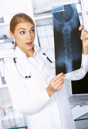 Surprised female doctor examining x-ray picture Stock Photo - Budget Royalty-Free & Subscription, Code: 400-04075514