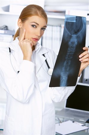 simsearch:400-04178933,k - Thinking female doctor and examining x-ray picture Stock Photo - Budget Royalty-Free & Subscription, Code: 400-04075518