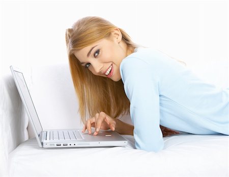 Young woman sitting on couch and working on laptop Stock Photo - Budget Royalty-Free & Subscription, Code: 400-04075573