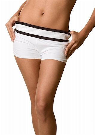 Midsection of woman body from knees to stomach part. Female wearing just white shorts and her bare belly and naval is uncovered Stock Photo - Budget Royalty-Free & Subscription, Code: 400-04076167