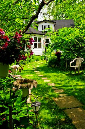 stepping on flowers - Path of steeping stones leading to a house in lush green garden Stock Photo - Budget Royalty-Free & Subscription, Code: 400-04070065