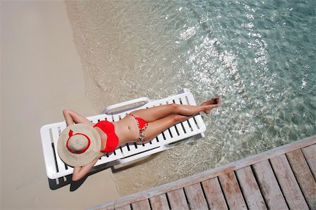 simsearch:6102-08388289,k - Pretty woman lying on the beach from an overhead perspective Stock Photo - Budget Royalty-Free & Subscription, Code: 400-04070484