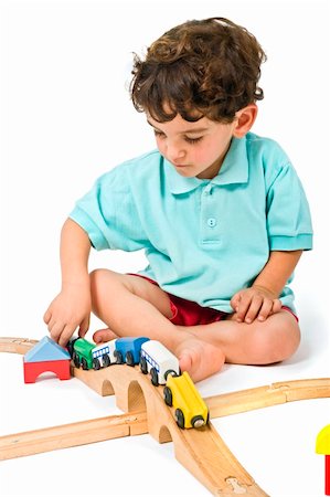 school rooms backgrounds - little boy playing with toy train isolated on white Stock Photo - Budget Royalty-Free & Subscription, Code: 400-04070487