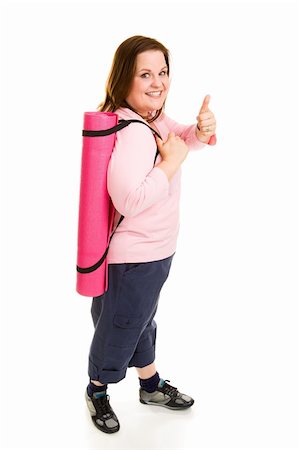Healthy plus sized model gives thumbs up sign on the way to the gym with her yoga mat.  Full body isolated on white. Foto de stock - Super Valor sin royalties y Suscripción, Código: 400-04070948