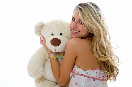 simsearch:400-06758392,k - Happy sexy girl with teddy bear on a bedroom isolated on white background Photographie de stock - Aubaine LD & Abonnement, Code: 400-04071099