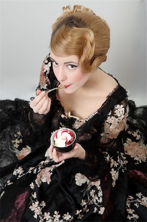 Ice-cream Chocolate pretty young lady  in old time ball dress with fan  in  style of the end of XIX century Stock Photo - Budget Royalty-Free & Subscription, Code: 400-04071134