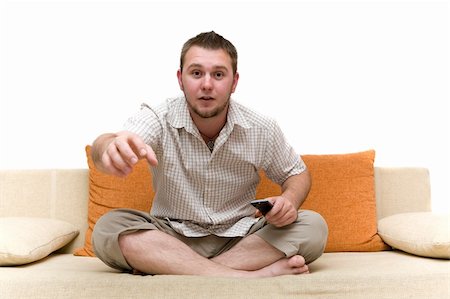 simsearch:400-04540885,k - casual man watching tv on sofa Foto de stock - Royalty-Free Super Valor e Assinatura, Número: 400-04071611