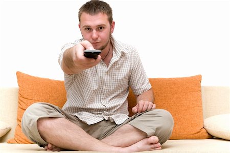 simsearch:400-04540885,k - casual man watching tv on sofa Foto de stock - Royalty-Free Super Valor e Assinatura, Número: 400-04071626