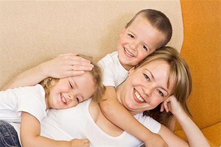 Woman laying on the sofa with her kids Stock Photo - Budget Royalty-Free & Subscription, Code: 400-04071640