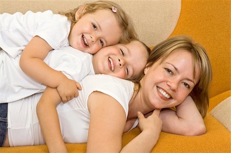 Happy woman and kids playing on the sofa Foto de stock - Super Valor sin royalties y Suscripción, Código: 400-04071642