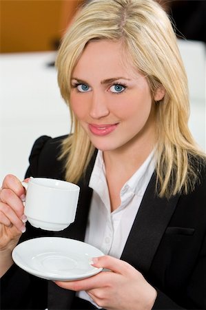 simsearch:400-04188263,k - An attractive young female executive takes a coffee break in the office Foto de stock - Super Valor sin royalties y Suscripción, Código: 400-04071715