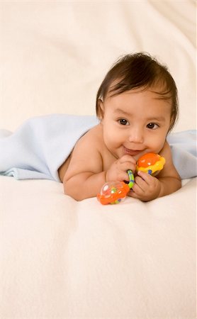 cute kid lying down on his tummy on blanket with stuck out tongue Stock Photo - Budget Royalty-Free & Subscription, Code: 400-04071764