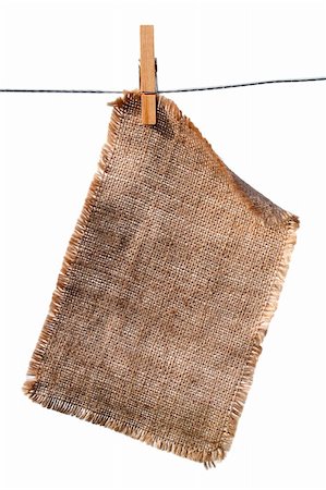 burlap canvas with lacerate edges hanging with wooden peg, isolated on white Foto de stock - Royalty-Free Super Valor e Assinatura, Número: 400-04072356