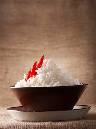 rice bowl with fresh chillies on brown rustic background, Low Key Lighting Technique, Shallow DOF Foto de stock - Royalty-Free Super Valor e Assinatura, Número: 400-04072362