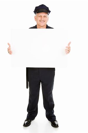 Full body view of a friendly police officer (or security guard) holding a blank white sign.  Isolated on white and ready for your text. Photographie de stock - Aubaine LD & Abonnement, Code: 400-04073023