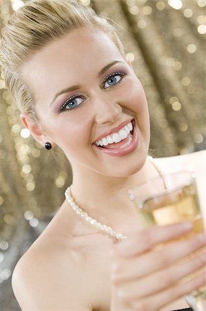 pretty woman laughter party - A beautiful young blond haired, blue eyed woman enjoying a glass of champagne Stock Photo - Budget Royalty-Free & Subscription, Code: 400-04073131
