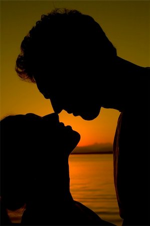 A silhouette of a couple about to kiss. Stock Photo - Budget Royalty-Free & Subscription, Code: 400-04073151