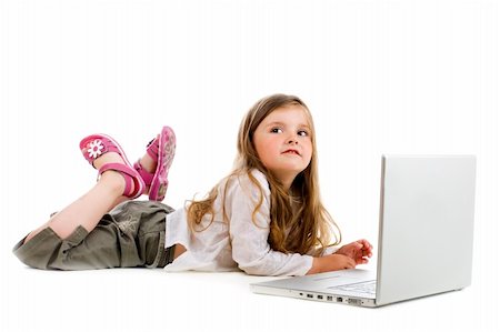 Adorable caucasian little girl lying with laptop Stock Photo - Budget Royalty-Free & Subscription, Code: 400-04073163