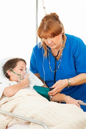 patient on bed and iv - Friendly nurse takes the blood pressure of a sick little boy in the hospital. Stock Photo - Budget Royalty-Free & Subscription, Code: 400-04085060