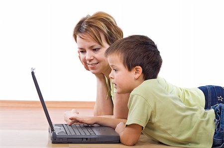 simsearch:400-05882478,k - Child surfing the net under supervision - isolated, focus on the boy face Stock Photo - Budget Royalty-Free & Subscription, Code: 400-04085089