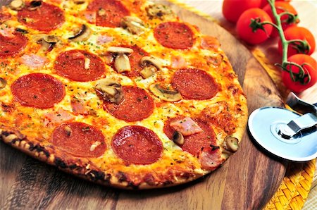 pizza wood - Freshly baked pepperoni pizza on wooden board Stock Photo - Budget Royalty-Free & Subscription, Code: 400-04081043