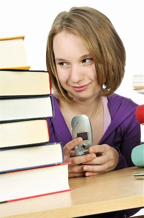 sitting in a school desk texting - Teenage girl text messaging with cell phone in school Stock Photo - Budget Royalty-Free & Subscription, Code: 400-04081057