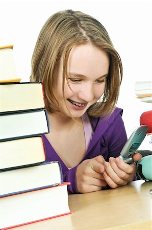 sitting in a school desk texting - Teenage girl text messaging with cell phone in school Stock Photo - Budget Royalty-Free & Subscription, Code: 400-04081058