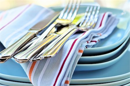 Table setting with stack of plates and cutlery Stock Photo - Budget Royalty-Free & Subscription, Code: 400-04081050