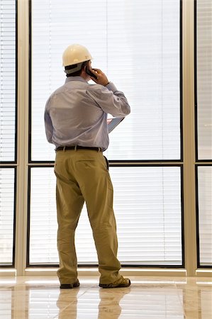 simsearch:400-04035450,k - An industrial concept shot showing a man dressed in a hard hat and talking on his phone Foto de stock - Royalty-Free Super Valor e Assinatura, Número: 400-04081816