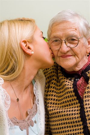 simsearch:400-04121486,k - A young woman kissing an older one  (focus on the elderly) - part of a series. Foto de stock - Super Valor sin royalties y Suscripción, Código: 400-04081831