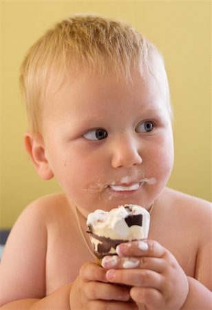 Dirty toddler boy easting ice cream - head and shoulders portrait Stock Photo - Budget Royalty-Free & Subscription, Code: 400-04081920
