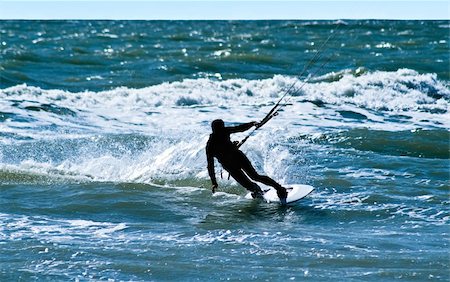 simsearch:400-05023877,k - Silhouette of a kitesurfer on waves of a sea Stock Photo - Budget Royalty-Free & Subscription, Code: 400-04082059