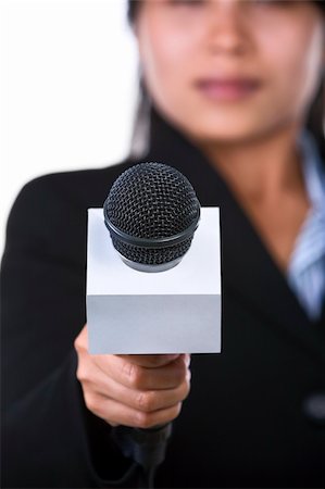 A woman is holding a microphone to the camera. Shot against white background. Stock Photo - Budget Royalty-Free & Subscription, Code: 400-04082414