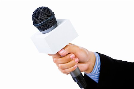 Side view of and hand using suit holding a microphone aiming to the empty space on the left. Focus mainly on the microphone. Stock Photo - Budget Royalty-Free & Subscription, Code: 400-04082415