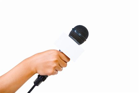 Side view of a bare hand holding a microphone aiming to the empty space on right with 90 degrees from the camera. Foto de stock - Super Valor sin royalties y Suscripción, Código: 400-04082417