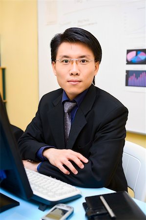 simsearch:400-04639378,k - An Asian businessman facing the camera in his office. Stock Photo - Budget Royalty-Free & Subscription, Code: 400-04082462