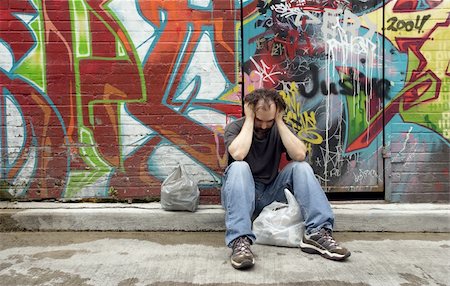 dirty city - A homeless man on the city streets, filled with anxiety and hopelessness. Stock Photo - Budget Royalty-Free & Subscription, Code: 400-04082944