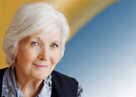 Senior woman portrait on blue and yellow background Fotografie stock - Microstock e Abbonamento, Codice: 400-04083408